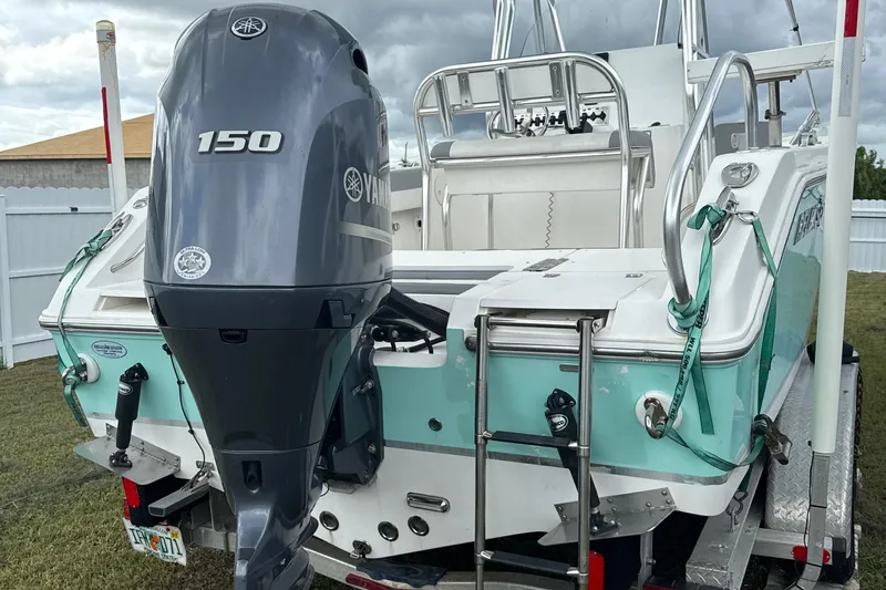Slide: The Image of 2018 Release 208 RX boat with Yamaha 150 outboard motor, parked on trailer. - 3