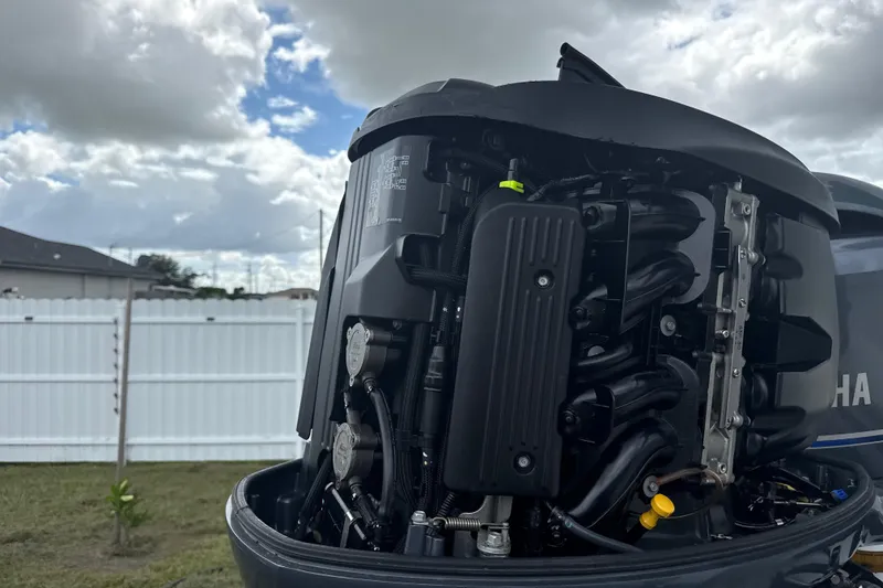 Slide: The Image of Close-up of a Yamaha outboard motor, showcasing engine details under a cloudy sky. - 4