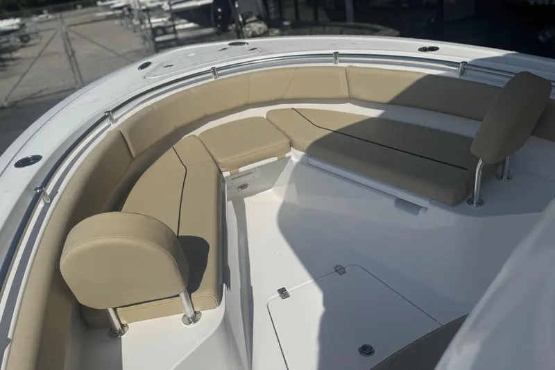 Slide: The Image of 2026 Sportsman Open 232 Center Console boat with beige seating in the bow area. - 10