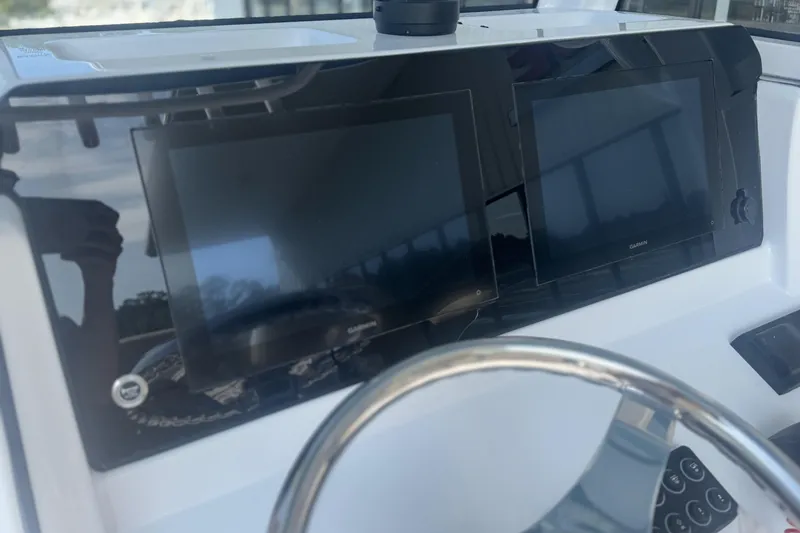 Slide: The Image of 2026 Sportsman Open 232 Center Console dashboard with dual Garmin displays. - 11