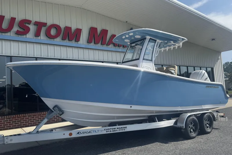 Slide: The Image of 2026 Sportsman Open 232 Center Console boat on trailer outside Custom Marine. - 16