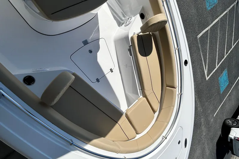Slide: The Image of 2026 Sportsman Open 232 Center Console boat interior with tan seating and white deck. - 23