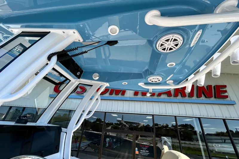 Slide: The Image of 2026 Sportsman Open 232 Center Console boat at Custom Marine dealership. - 25