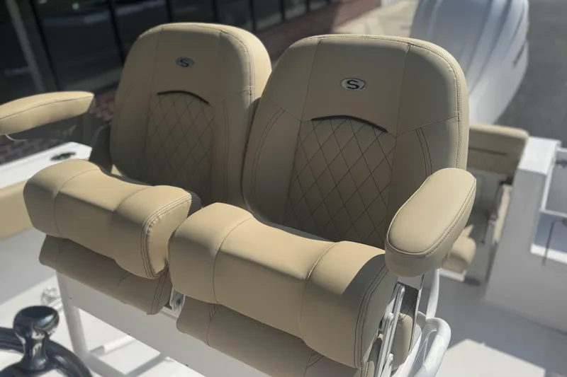 Slide: The Image of 2026 Sportsman Open 232 Center Console boat seats, beige leather, diamond stitching. - 6