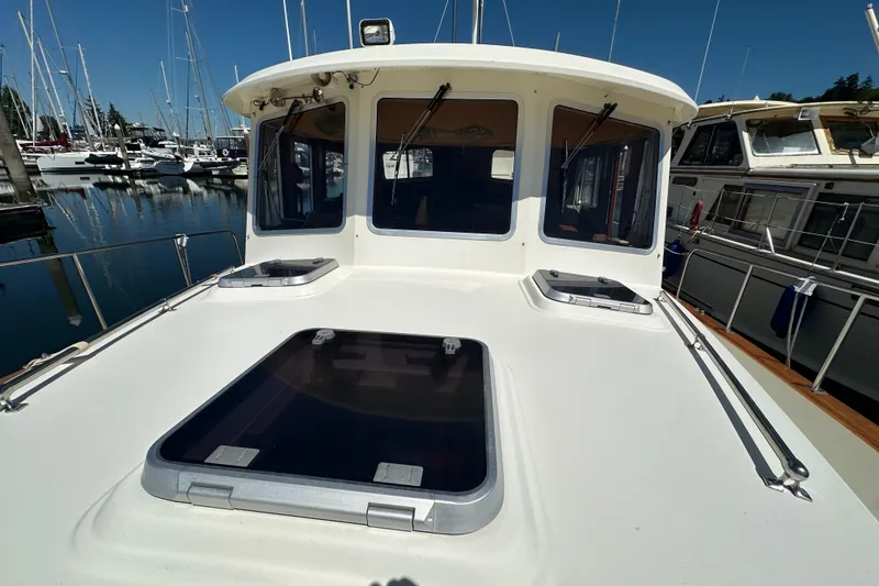 Slide: The Image of Eagle 40 Pilothouse Trawler 2000 at marina, showcasing deck and pilothouse windows. - 14