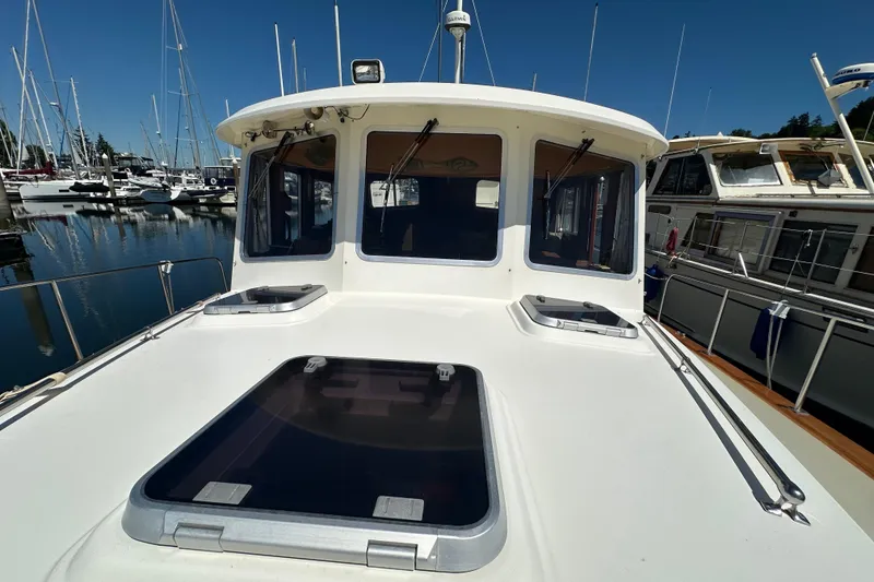 Slide: The Image of Eagle 40 Pilothouse Trawler 2000 at marina, showcasing deck and pilothouse. - 15