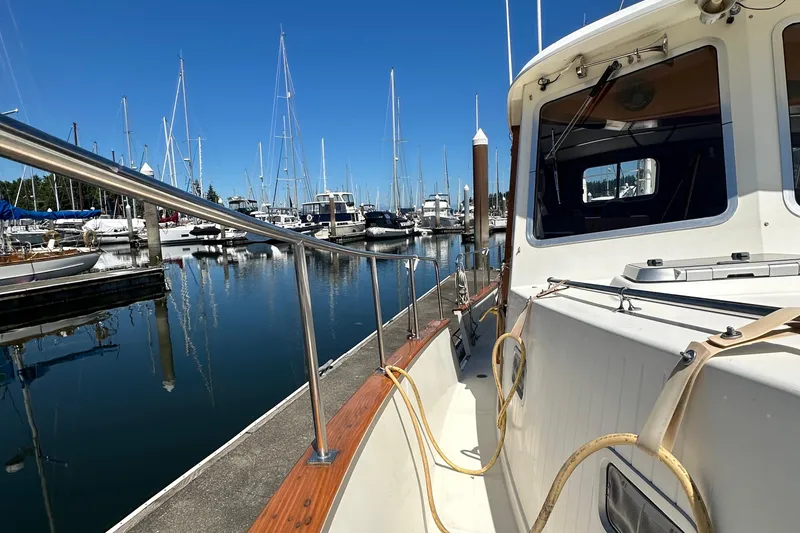 Slide: The Image of 2000 Eagle 40 Pilothouse Trawler docked at marina, surrounded by sailboats. - 17