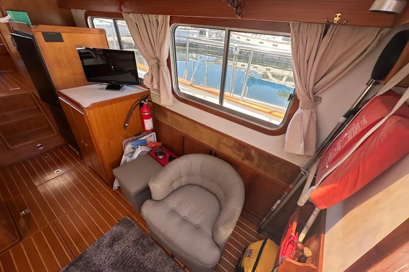 Slide: The Image of Interior of 2000 Eagle 40 Pilothouse Trawler with cozy seating and nautical decor. - 20