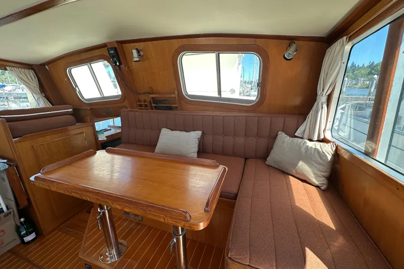 Slide: The Image of Interior of 2000 Eagle 40 Pilothouse Trawler with wood finish and cozy seating area. - 28