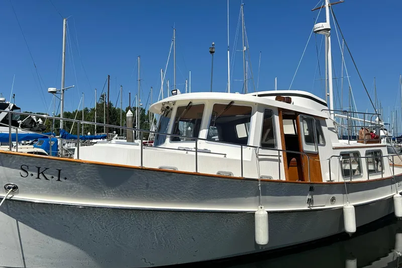 Slide: The Image of 2000 Eagle 40 Pilothouse Trawler docked at marina under clear blue sky. - 3