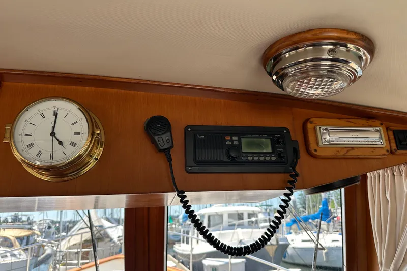Slide: The Image of Interior of 2000 Eagle 40 Pilothouse Trawler with clock, radio, and light fixture. - 34