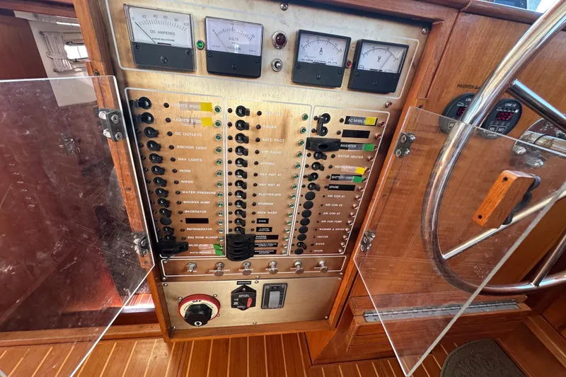 Slide: The Image of Control panel of a 2000 Eagle 40 Pilothouse Trawler with gauges and switches. - 48
