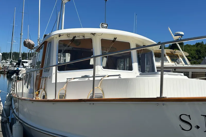 Slide: The Image of 2000 Eagle 40 Pilothouse Trawler docked at marina under clear blue sky. - 5
