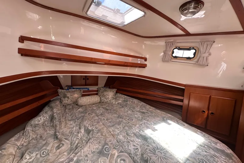 Slide: The Image of Cozy cabin interior of 2000 Eagle 40 Pilothouse Trawler with wood accents and bedding. - 54