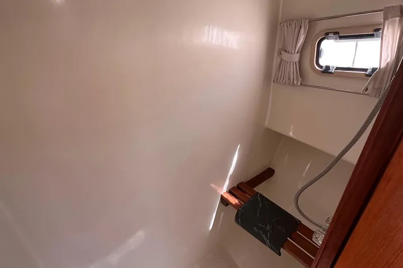 Slide: The Image of Bathroom interior of 2000 Eagle 40 Pilothouse Trawler with shower and window. - 56