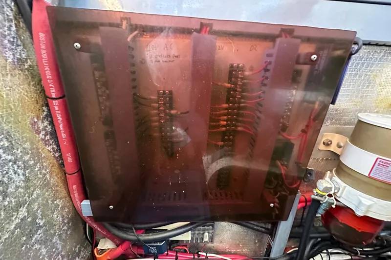 Slide: The Image of Electrical panel inside a 2000 Eagle 40 Pilothouse Trawler, featuring wiring and components. - 62