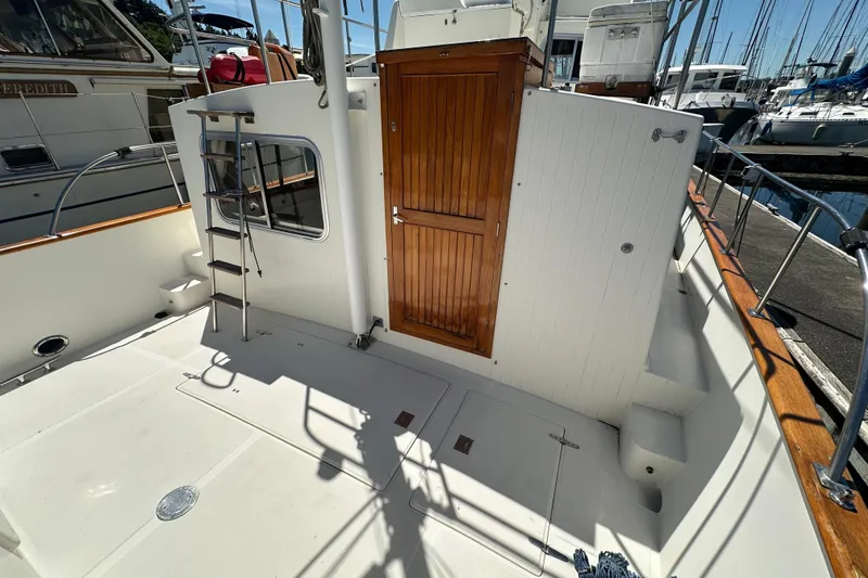 Slide: The Image of Eagle 40 Pilothouse Trawler 2000, featuring a wooden door and ladder on deck. - 7