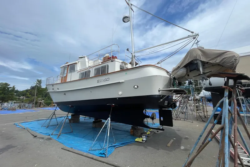 Slide: The Image of Eagle 40 Pilothouse Trawler 2000 on dry dock for maintenance under a cloudy sky. - 73