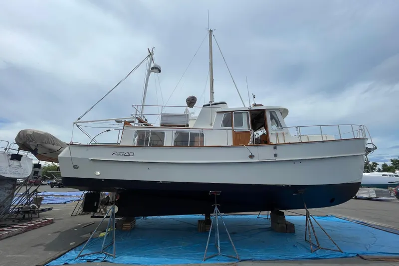Slide: The Image of 2000 Eagle 40 Pilothouse Trawler on dry dock, showcasing its classic design and structure. - 76