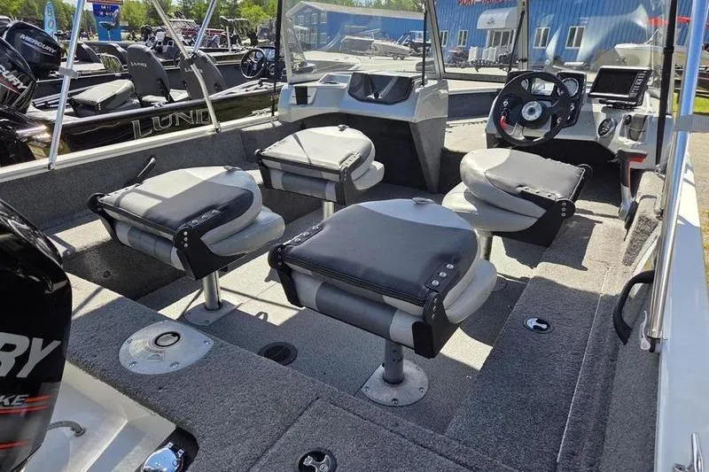 Slide: The Image of 2018 Tracker PG V16 WT boat interior with seating and steering console. - 11