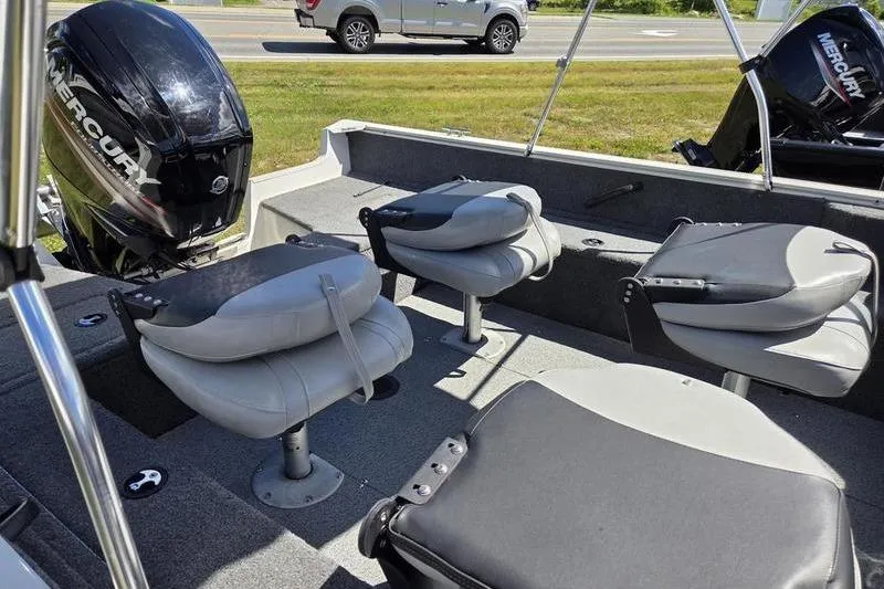Slide: The Image of 2018 Tracker PG V16 WT boat interior with four gray seats and Mercury outboard motor. - 12