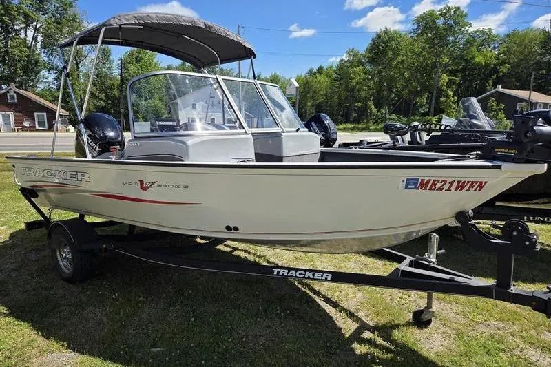 Slide: The Image of 2018 Tracker PG V16 WT boat on trailer, parked outdoors. - 8