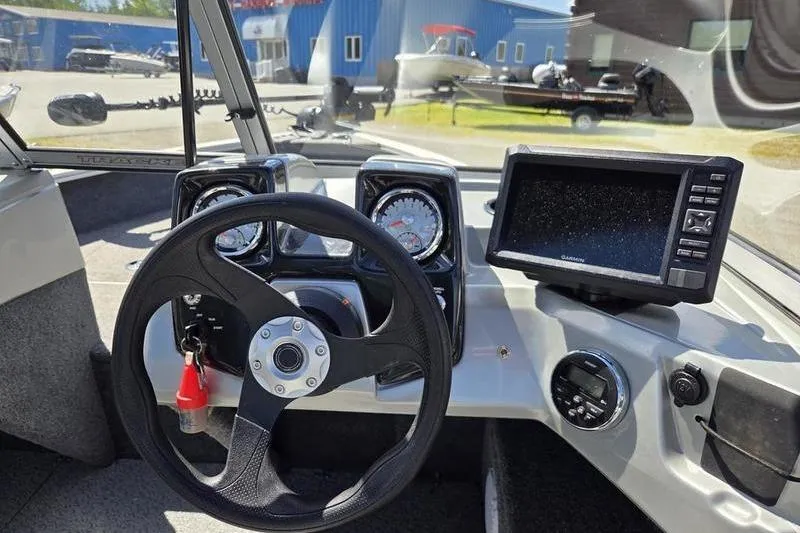 Slide: The Image of 2018 Tracker PG V16 WT boat dashboard with steering wheel and Garmin display. - 9