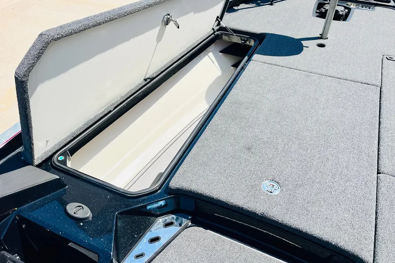 Slide: The Image of 2024 Ranger Z521R boat storage compartment with open lid, showcasing spacious interior. - 16