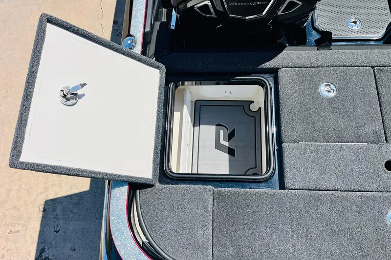 Slide: The Image of 2024 Ranger Z521R Ranger Cup Equipped boat storage compartment with open lid and key. - 48