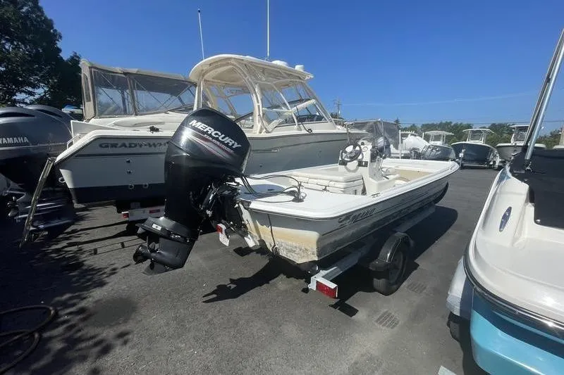 Slide: The Image of 2014 Mako Pro Skiff 17 CC with Mercury outboard motor in a boatyard. - 5