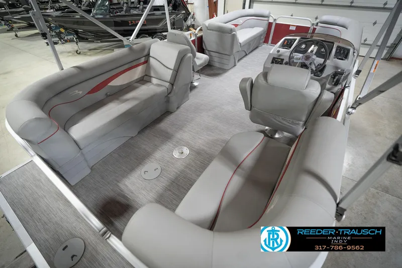Slide: The Image of 2021 Bennington 20 SVSR pontoon boat interior with gray seating and steering console. - 14