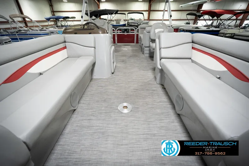 Slide: The Image of 2021 Bennington 20 SVSR pontoon boat interior with gray seating and red accents. - 16