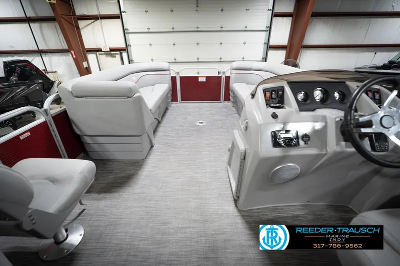 Slide: The Image of Interior of a 2021 Bennington 20 SVSR pontoon boat with plush seating and modern dashboard. - 20