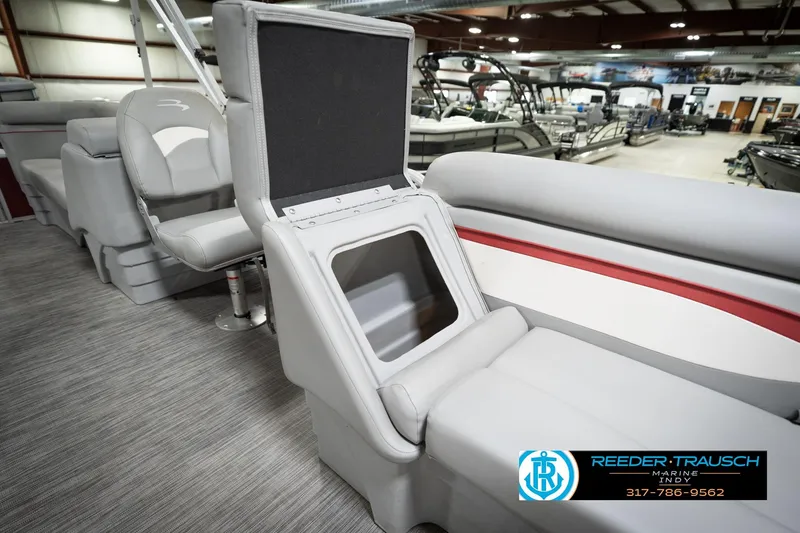 Slide: The Image of 2021 Bennington 20 SVSR pontoon boat interior with open storage compartment in showroom. - 24