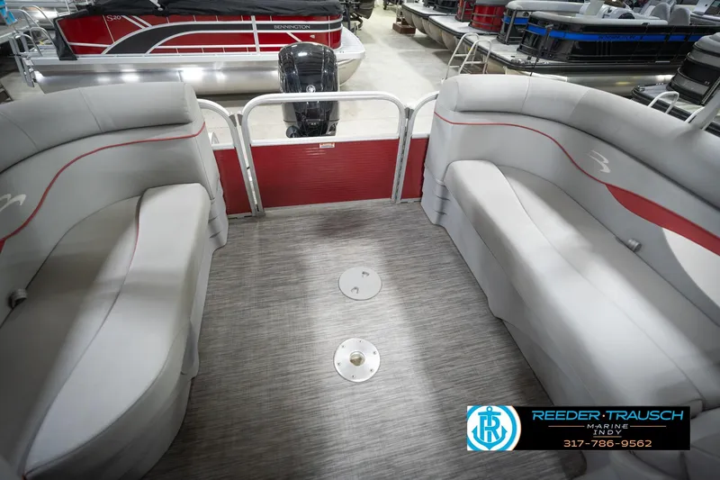 Slide: The Image of 2021 Bennington 20 SVSR pontoon boat interior with gray seating and red accents. - 27