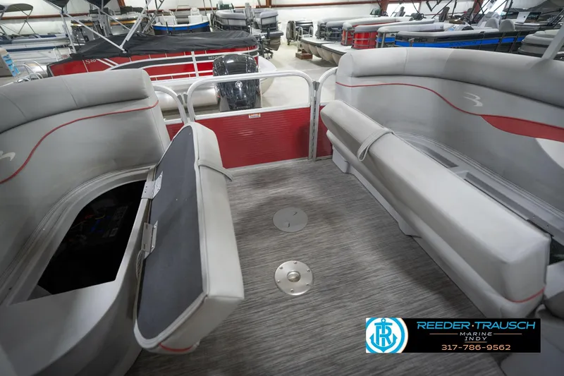 Slide: The Image of 2021 Bennington 20 SVSR pontoon boat interior with gray seating and storage compartments. - 28