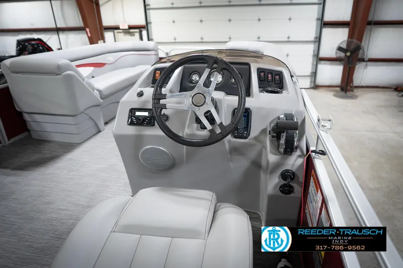 Slide: The Image of 2021 Bennington 20 SVSR boat interior with steering wheel and seating in a showroom. - 29