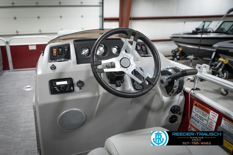 Slide: The Image of 2021 Bennington 20 SVSR boat dashboard with steering wheel and controls in a showroom. - 30
