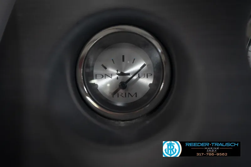 Slide: The Image of Close-up of a 2021 Bennington 20 SVSR trim gauge, showing "DN" and "UP" indicators. - 34