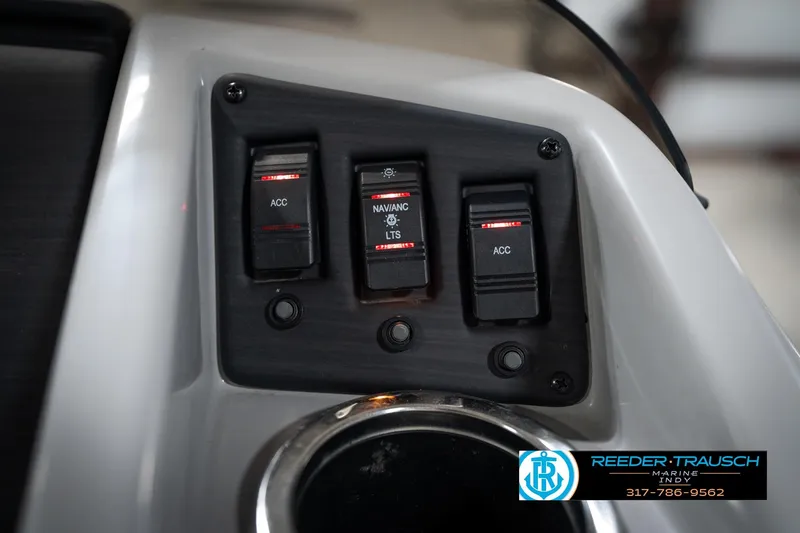 Slide: The Image of Control panel of a 2021 Bennington 20 SVSR boat with switches and cup holder. - 38
