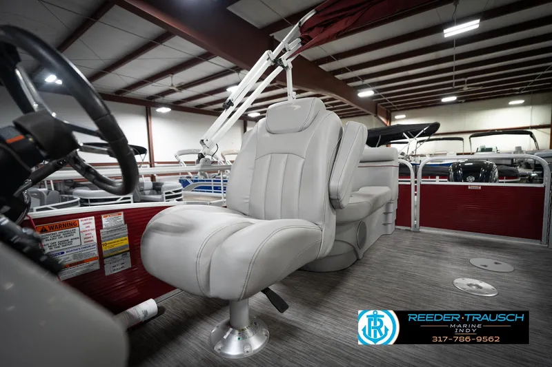 Slide: The Image of 2021 Bennington 20 SVSR pontoon boat interior with plush seating in showroom. - 41