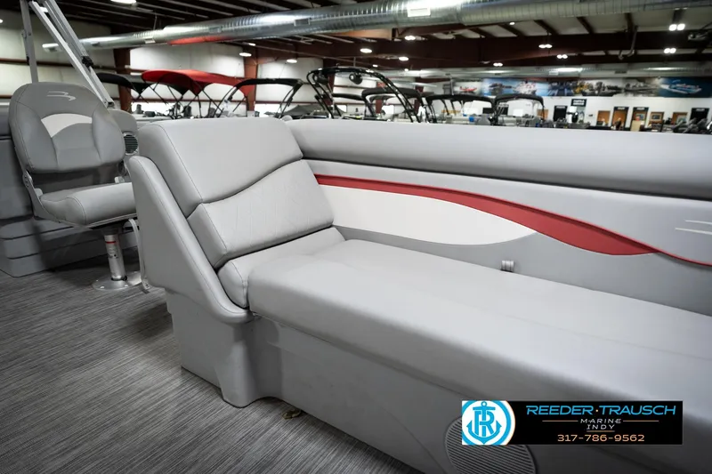 Slide: The Image of 2021 Bennington 20 SVSR pontoon boat interior with gray seating and red accents. - 43