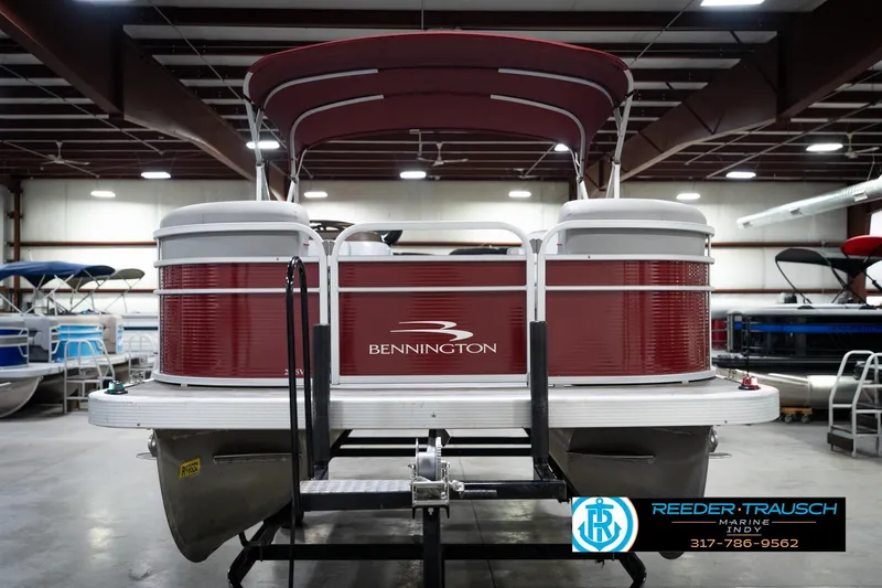 Slide: The Image of 2021 Bennington 20 SVSR pontoon boat in showroom, red and white design. - 5