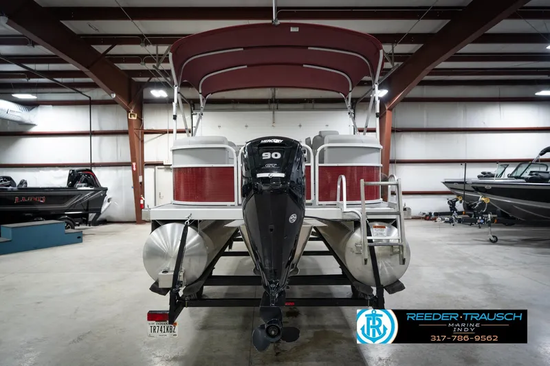 Slide: The Image of 2021 Bennington 20 SVSR pontoon boat in indoor showroom with Mercury outboard motor. - 9