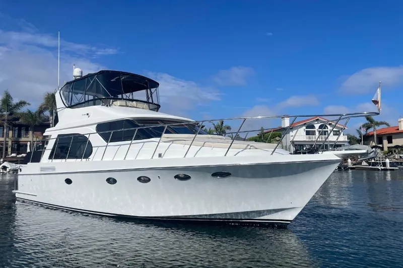 The Image of 2003 Ocean Alexander 420 Sport Sedan in harbor, blue sky. - 0