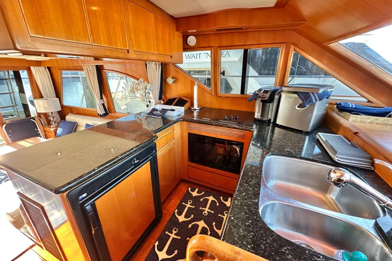 Slide: The Image of Luxurious 2003 Ocean Alexander 42 Sport Sedan yacht interior with modern kitchen and elegant wood finishes. - 11