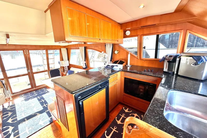 Slide: The Image of Luxurious 2003 Ocean Alexander 42 Sport Sedan yacht interior with modern kitchen and elegant wood finishes. - 15