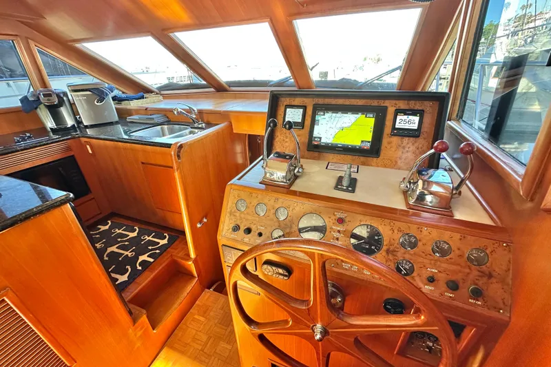 Slide: The Image of 2003 Ocean Alexander 42 Sport Sedan helm with navigation controls and kitchen area. - 17