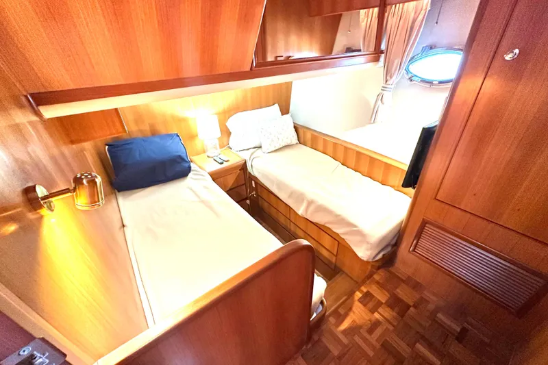 Slide: The Image of Cozy twin cabin in 2003 Ocean Alexander 42 Sport Sedan yacht, featuring wooden interiors. - 24