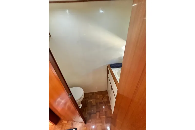 Slide: The Image of Bathroom interior of 2003 Ocean Alexander 42 Sport Sedan yacht, featuring wood accents and compact design. - 25
